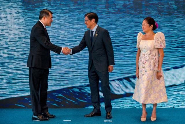 Vietnam Prime Minister Le Minh Hung (L) is greeted by Philippine President Ferdinand Marcos Jr. and his wife Liza Araneta Marcos during a welcome ceremony for the 48th Association of Southeast Asian Nations (ASEAN) summit in Cebu, central Philippines on May 8, 2026. (Photo by Ezra Acayan / POOL / AFP)