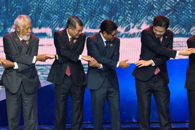(L-R) East Timor's Prime Minister Xanana Gusmao, Vietnam's Prime Minister Le Minh Hung, Philippine President Ferdinand Marcos Jr. and Singapore's Prime Minister Lawrence Wong hold hands for a group photo during a welcome ceremony for the 48th Association of Southeast Asian Nations (ASEAN) summit in Cebu, central Philippines on May 8, 2026. (Photo by Aaron FAVILA / POOL / AFP)