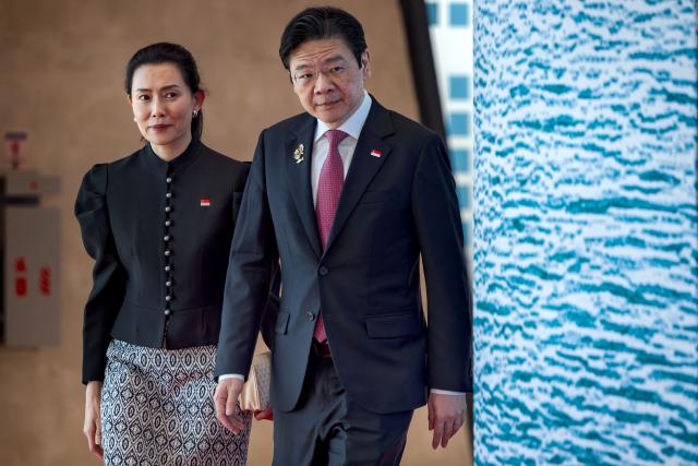 Singapore Prime Minister Lawrence Wong and his wife Loo Tze Lui arrive for a welcome ceremony during the 48th Association of Southeast Asian Nations (ASEAN) summit in Cebu, central Philippines on May 8, 2026. (Photo by Ezra Acayan / POOL / AFP)