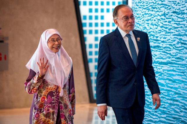 Malaysian Prime Minister Anwar Ibrahim and his wife Wan Azizah Wan Ismail arrive for a welcome ceremony during the 48th Association of Southeast Asian Nations (ASEAN) summit in Cebu, central Philippines on May 8, 2026. (Photo by Ezra Acayan / POOL / AFP)