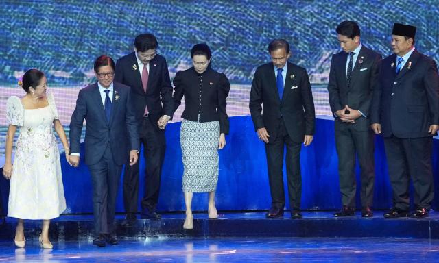 (L-R) Philippine President Ferdinand Marcos Jr. and his wife Louise, Singapore's Prime Minister Lawrence Wong and his wife Loo Tze Lui, Brunei's Sultan Hassanal Bolkiah and his son Prince Abdul Mateen and Indonesia's President Prabowo Subianto leave the stage after a group photo during a welcome ceremony for the 48th Association of Southeast Asian Nations (ASEAN) summit in Cebu, central Philippines on May 8, 2026. (Photo by Aaron FAVILA / POOL / AFP)