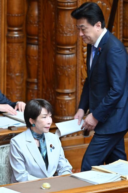 Japan's Prime Minister Sanae Takaichi (L) and Chief Cabinet Secretary Minoru Kihara attend the House of Councillors plenary session to explain the purpose of the bill to establish the National Intelligence Council at parliament in Tokyo on May 8, 2026. (Photo by Kazuhiro NOGI / AFP)