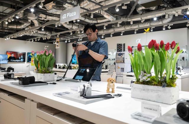 A customer looks at a camera at a Sony showroom in Tokyo on May 8, 2026. Japanese electronics giant Sony on May 8 forecast a 13 percent rise in net profit for the year to next March, boosted by its video games operations. (Photo by Andrew CABALLERO-REYNOLDS / AFP)