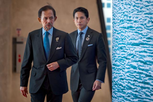 Brunei Sultan Hassanal Bolkiah and his son Prince Abdul Mateen arrive for a welcome ceremony during the 48th Association of Southeast Asian Nations (ASEAN) summit in Cebu, central Philippines on May 8, 2026. (Photo by Ezra Acayan / POOL / AFP)