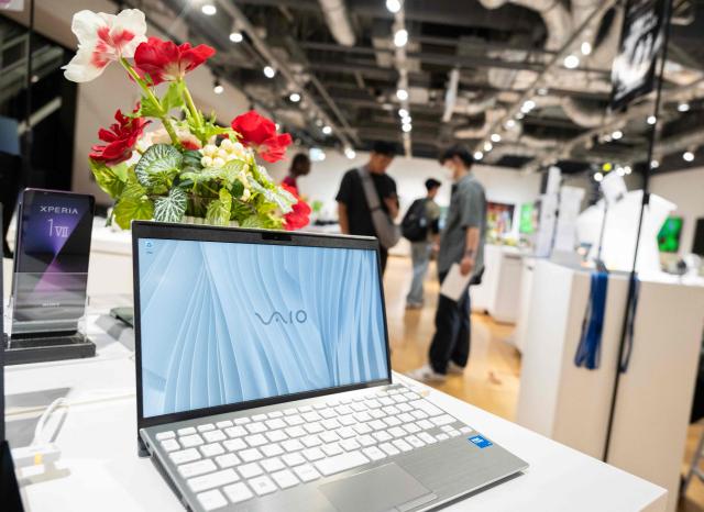Customers look at laptops at a Sony showroom in Tokyo on May 8, 2026. Japanese electronics giant Sony on May 8 forecast a 13 percent rise in net profit for the year to next March, boosted by its video games operations. (Photo by Andrew CABALLERO-REYNOLDS / AFP)