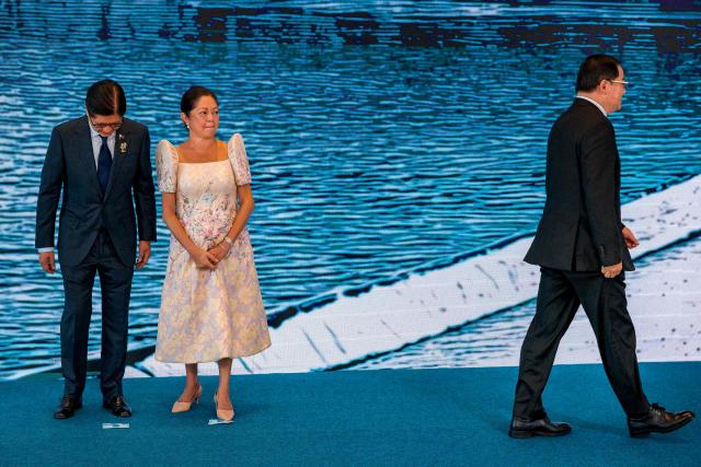 Philippine President Ferdinand Marcos Jr. and his wife Liza Araneta Marcos look on as Laos Prime Minister Sonexay Siphandone walks off stage following their group photo during the welcome ceremony of the 48th Association of Southeast Asian Nations (ASEAN) summit in Cebu, central Philippines on May 8, 2026. (Photo by Ezra Acayan / POOL / AFP)