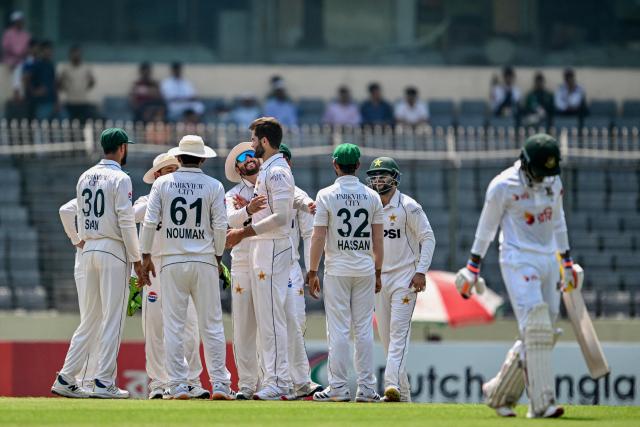 Pakistan's Shaheen Shah Afridi (C) celebrates with teammates after taking the wicket of Bangladesh's Mahmudul Hasan Joy (R) during the first test cricket match between Bangladesh and Pakistan at the Sher-e-Bangla National Stadium in Mirpur on May 8, 2026. (Photo by Munir UZ ZAMAN / AFP)