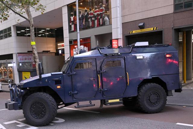 An armoured police vehicle transports two women linked to alleged Islamic State jihadists away from the Melbourne Magistrates Court in Melbourne on May 8, 2026, after their court appearance. Two Australian women "kept a female slave" after travelling to Syria in 2014 to support the Islamic State group, police said on May 8 after they were charged in Melbourne. The pair returned to Australia on the evening of May 7 for the first time in almost a decade, travelling from a Syrian detention camp where they were stranded after the group's collapse. (Photo by WILLIAM WEST / AFP)