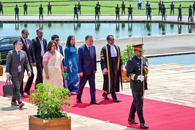 Vietnam's President To Lam (3R), along with Sri Lanka's parliament speaker Jagath Wickramaratne (2R), arrives to address Sri Lankan Parliament during his official visit in Colombo on May 8, 2026. (Photo by Ishara S. KODIKARA / AFP)