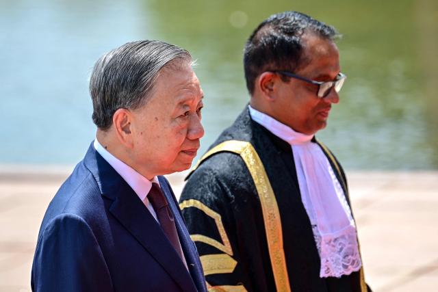 Vietnam's President To Lam (L), along with Sri Lanka's parliament speaker Jagath Wickramaratne arrives to address Sri Lankan Parliament during his official visit in Colombo on May 8, 2026. (Photo by Ishara S. KODIKARA / AFP)