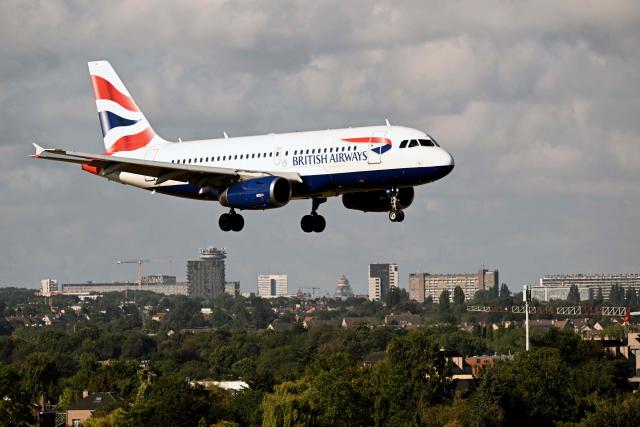 (FILES) A British Airways aircraft is about to land on the tarmac at Zaventem airport in Brussels on August 21, 2025. IAG, parent group of British Airways and Spanish carrier Iberia, said on May 8, 2026 that the Middle East war will lower its annual profits despite a strong start to 2026. (Photo by Nicolas TUCAT / AFP)