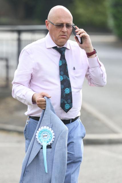 A newly elected Reform UK councillor waits for the arrival of Reform UK leader Nigel Farage to arrive outside the Havering Town Hall a day after local elections in east London on May 8, 2026. (Photo by Toby Shepheard / AFP)