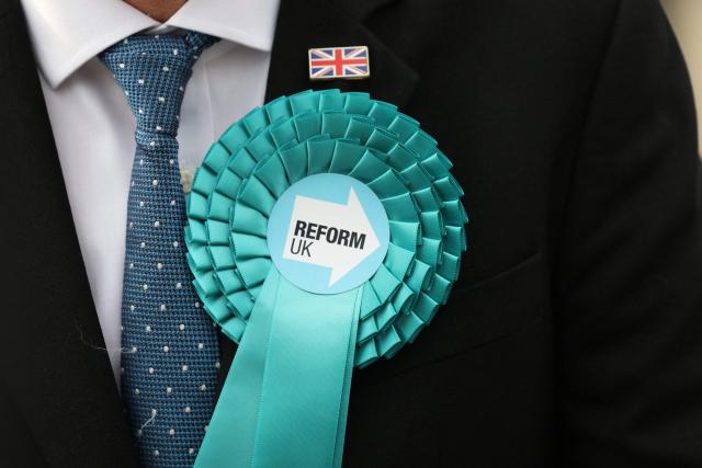 A member of the Reform UK party waits for the arrival of Reform UK leader Nigel Farage to arrive outside the Havering Town Hall a day after local elections in east London on May 8, 2026. (Photo by Toby Shepheard / AFP)