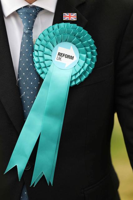 A member of the Reform UK party waits for the arrival of Reform UK leader Nigel Farage to arrive outside the Havering Town Hall a day after local elections in east London on May 8, 2026. (Photo by Toby Shepheard / AFP)