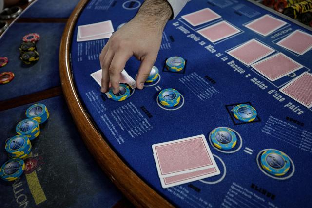 (FILES) An apprentice croupier attends a training session at the All'in Casino Experts school in Saint-Cloud on March 26, 2026. Freshly trained, 45 croupiers are eager to take to the floor: on May 12, 2026 in Paris, the Partouche Casino Club – the capital’s largest gaming club – is set to open a new four-storey, 5,000-square-metre gaming club near the Champs-Йlysйes avenue. (Photo by STEPHANE DE SAKUTIN / AFP)