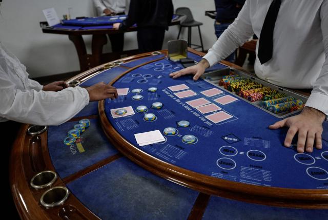 (FILES) Apprentice croupiers attend a training session at the All'in Casino Experts school in Saint-Cloud on March 26, 2026. Freshly trained, 45 croupiers are eager to take to the floor: on May 12, 2026 in Paris, the Partouche Casino Club – the capital’s largest gaming club – is set to open a new four-storey, 5,000-square-metre gaming club near the Champs-Йlysйes avenue. (Photo by STEPHANE DE SAKUTIN / AFP)