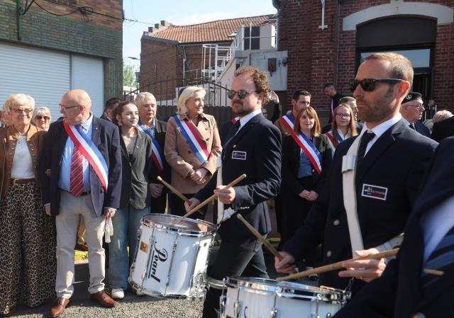President of French far right Rassemblement National parliamentary group Marine Le Pen (Rear C) attends a ceremony marking the 81st anniversary of VE Day, or Victory in Europe Day, which commemorates the end of World War II, in Oignies, northern France, on May 8, 2026. (Photo by Francois LO PRESTI / AFP)