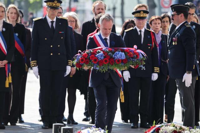 Paris' mayor Emmanuel Gregoire lays a wreath of flowers at the Arc de Triomphe monument during a ceremony marking the 81st anniversary of Victory in Europe Day, which commemorates the end of the Second World War in Europe, in Paris on 8 May 2026. (Photo by Ludovic MARIN / POOL / AFP)