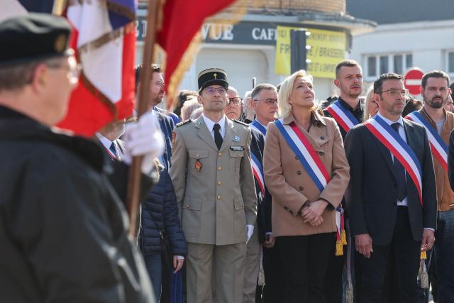 President of French far right Rassemblement National parliamentary group Marine Le Pen (C) and mayor of Oignies Francois Vial attend a ceremony marking the 81st anniversary of VE Day, or Victory in Europe Day, which commemorates the end of World War II, in Oignies, northern France, on May 8, 2026. (Photo by Francois LO PRESTI / AFP)