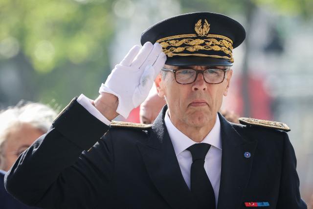 Prefect of the Ile-de-France region Marc Guillaume salutes as he stands guard in front of wreaths of flowers at the Arc de Triomphe monument during a ceremony marking the 81st anniversary of Victory in Europe Day, which commemorates the end of the Second World War in Europe, in Paris on 8 May 2026. (Photo by Ludovic MARIN / POOL / AFP)