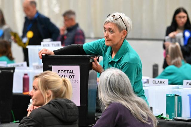 A staff member prepares to open a postal ballot box to count votes the morning after parliamentary elections at the Dewars Centre in Perth, Perthshire, Scotland on May 8, 2026. (Photo by ANDY BUCHANAN / AFP)