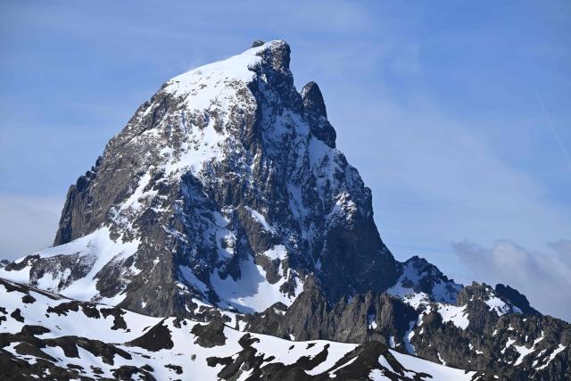 This photograph shows a view of the Pic d'Ossau mountain peak of the Pyrenees near Laruns, south-western France, on May 7, 2026. The Artouste little train is located in the Ossau Valley, in the Pyrenees-Atlantiques department of France. This historic tourist railway offers a mountain excursion at an altitude of over 2,000 meters. It travels 10 kilometers on its narrow-gauge track. It is the highest narrow-gauge railway in Europe. (Photo by Gaizka IROZ / AFP)