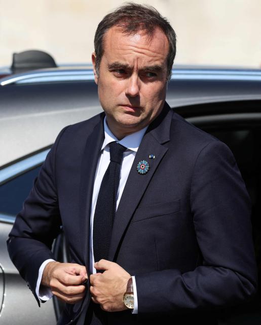 France's Prime Minister Sebastien Lecornu reacts upon arrival at the Arc de Triomphe for a ceremony marking the 81st anniversary of Victory in Europe Day, which commemorates the end of the Second World War in Europe, in Paris on 8 May 2026. (Photo by Ludovic MARIN / POOL / AFP)