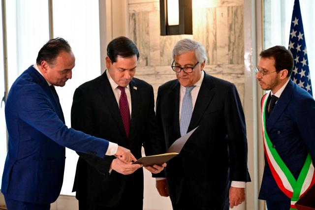 Italy's Deputy Prime Minister and Foreign Minister, Antonio Tajani (2ndR), Piedmont Region President Alberto Ciro (L) and Mayor of Casal Monferrato Emanuele Capra (R) present to U.S. Secretary of State Marco Rubio (2ndL) the family tree and documents that certify Secretary Rubio's family origins during an Italian Citizenship Conferment Ceremony at the Palazzo della Farnesina, Italy's Foreign Ministry in Rome on May 8, 2026. (Photo by Stefano RELLANDINI / POOL / AFP)