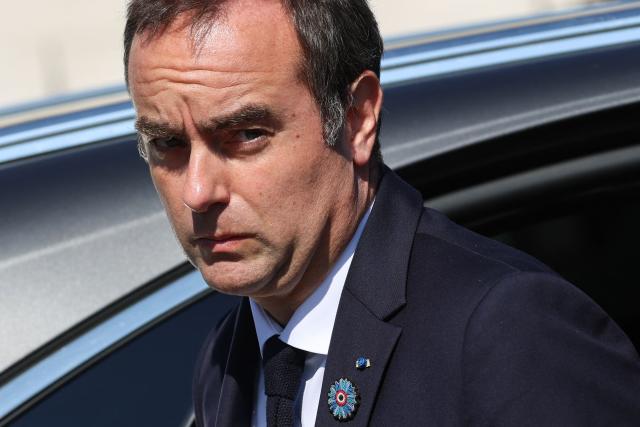 France's Prime Minister Sebastien Lecornu reacts upon arrival at the Arc de Triomphe for a ceremony marking the 81st anniversary of Victory in Europe Day, which commemorates the end of the Second World War in Europe, in Paris on 8 May 2026. (Photo by Ludovic MARIN / POOL / AFP)