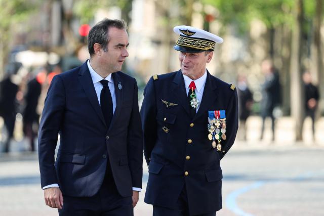 France's Prime Minister Sebastien Lecornu (L) and General Chief of Staff of the French Armed Forces Fabien Mandon (R) speak upon arrival at the Arc de Triomphe for a ceremony marking the 81st anniversary of Victory in Europe Day, which commemorates the end of the Second World War in Europe, in Paris on 8 May 2026. (Photo by Ludovic MARIN / POOL / AFP)