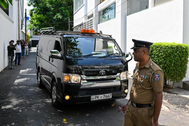 A vehicle transporting the body of the former chief executive of SriLankan Airlines Kapila Chandrasena leaves a relative's home in Colombo on May 8, 2026. The former chief of Sri Lanka's state-owned airline, who was charged with corruption over the purchase of 10 Airbus aircraft, was found dead on May 8, police said. (Photo by Ishara S. KODIKARA / AFP)