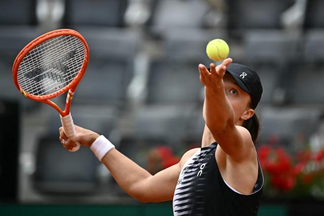 Poland's Iga Swiatek serves to US Caty McNally during their women's singles match of the WTA Rome Open tennis tournament at the Foro Italico in Rome on May 8, 2026. (Photo by Filippo MONTEFORTE / AFP)