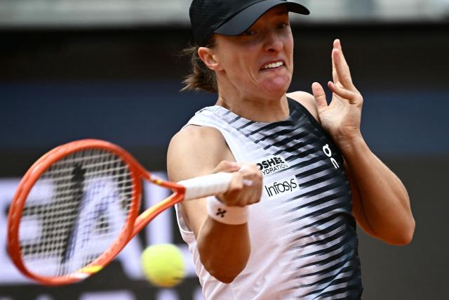 Poland's Iga Swiatek plays a forehand return to US Caty McNally during their women's singles match of the WTA Rome Open tennis tournament at the Foro Italico in Rome on May 8, 2026. (Photo by Filippo MONTEFORTE / AFP)