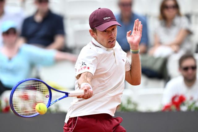 Australia's Alex de Minaur plays a forehand return to Italy's Matteo Arnaldi during their men's singles match of the WTA Rome Open tennis tournament at the Foro Italico in Rome on May 8, 2026. (Photo by Tiziana FABI / AFP)
