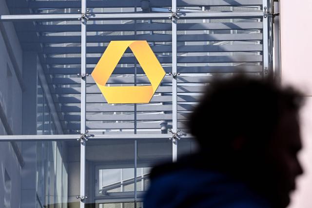 (FILES) Commerzbank's logo is pictured on the Commerzbank building in the banking district skyline in Frankfurt am Main, western Germany, on November 6, 2025. Germany's Commerzbank will cut up to 3,000 jobs as it battles to fend off a hostile takeover bid from Italy's UniCredit, the German firm said on May 8, 2026. (Photo by Kirill KUDRYAVTSEV / AFP)