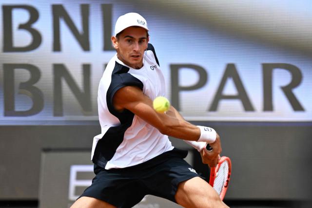 Italy's Matteo Arnaldi plays a backhand return to Australia's Alex de Minaur during their men's singles match of the WTA Rome Open tennis tournament at the Foro Italico in Rome on May 8, 2026. (Photo by Tiziana FABI / AFP)