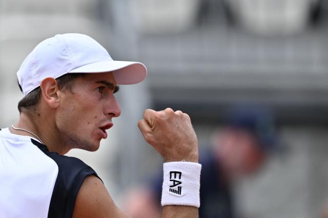 Italy's Matteo Arnaldi reacts after a point as he plays against Australia's Alex de Minaur during their men's singles match of the WTA Rome Open tennis tournament at the Foro Italico in Rome on May 8, 2026. (Photo by Tiziana FABI / AFP)