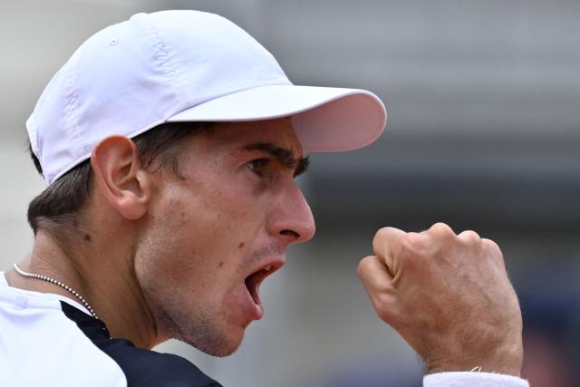 Italy's Matteo Arnaldi reacts after a point as he plays against Australia's Alex de Minaur during their men's singles match of the WTA Rome Open tennis tournament at the Foro Italico in Rome on May 8, 2026. (Photo by Tiziana FABI / AFP)