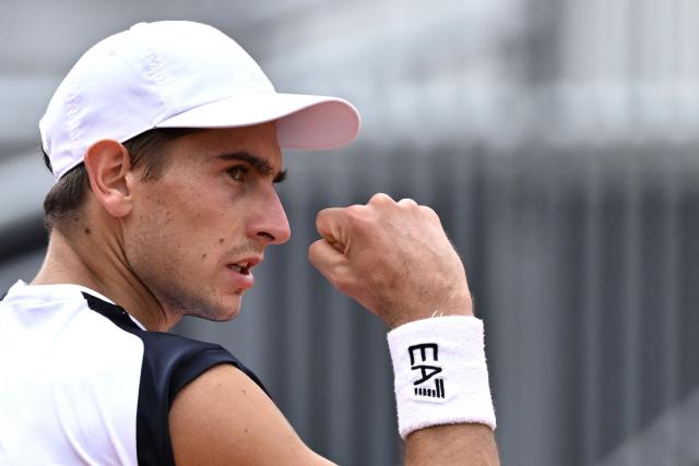 Italy's Matteo Arnaldi reacts after a point as he plays against Australia's Alex de Minaur during their men's singles match of the WTA Rome Open tennis tournament at the Foro Italico in Rome on May 8, 2026. (Photo by Tiziana FABI / AFP)