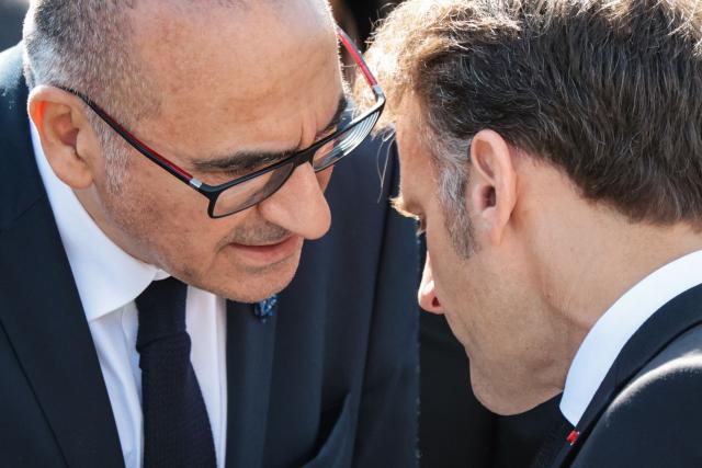 France's Interior Minister Laurent Nunez (L) speaks to France's President Emmanuel Macron (R) during a ceremony marking the 81st anniversary of Victory in Europe Day, which commemorates the end of the Second World War in Europe, at the Arc de Triomphe, in Paris on May 8, 2026. (Photo by Ludovic MARIN / POOL / AFP)