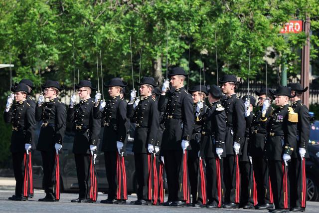 French Ecole Polytechnique members parade during a ceremony marking the 81st anniversary of Victory in Europe Day, which commemorates the end of the Second World War in Europe, at the Arc de Triomphe, in Paris on May 8, 2026. (Photo by Ludovic MARIN / POOL / AFP)