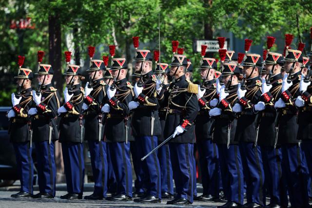 Members of France's Republican Guards (Garde Republicaine) parade during a ceremony marking the 81st anniversary of Victory in Europe Day, which commemorates the end of the Second World War in Europe, at the Arc de Triomphe, in Paris on May 8, 2026. (Photo by Ludovic MARIN / POOL / AFP)