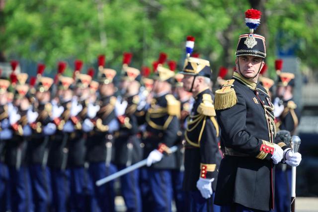 Members of France's Republican Guards (Garde Republicaine) parade during a ceremony marking the 81st anniversary of Victory in Europe Day, which commemorates the end of the Second World War in Europe, at the Arc de Triomphe, in Paris on May 8, 2026. (Photo by Ludovic MARIN / POOL / AFP)