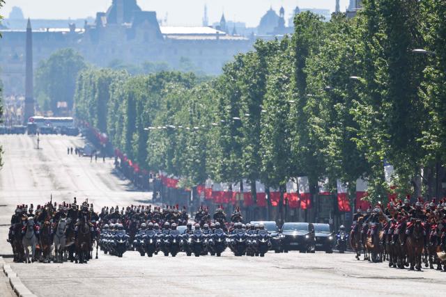 Members of France's Republican Guards (Garde Republicaine) parade down the Champs Elysees Avenue with the Luxor Obelisks of the place de la Concorde on the background, during a ceremony marking the 81st anniversary of Victory in Europe Day, which commemorates the end of the Second World War in Europe, at the Arc de Triomphe, in Paris on May 8, 2026. (Photo by Ludovic MARIN / POOL / AFP)