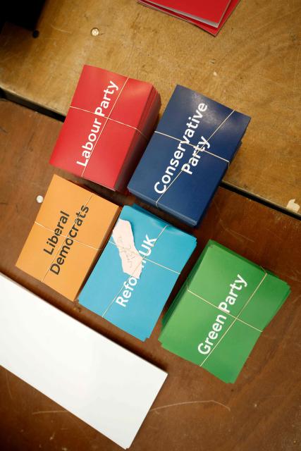 Leaflets coloured to match the Political parties are pictured as staff count votes on ballot papers the morning after local elections, at a vote-counting centre inside Alexandra Palace, north London on May 8, 2026. Nigel Farage, leader of the Britain's hard-right nationalist Reform UK party, vowed Friday it was "here to stay" after winning hundreds of seats in local polls. (Photo by Brook Mitchell / AFP)