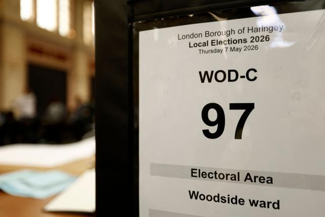 sealed ballot boxes wait to be emptied of ballot papers as staff count votes the morning after local elections, at a vote-counting centre inside Alexandra Palace, north London on May 8, 2026. Nigel Farage, leader of the Britain's hard-right nationalist Reform UK party, vowed Friday it was "here to stay" after winning hundreds of seats in local polls. (Photo by Brook Mitchell / AFP)