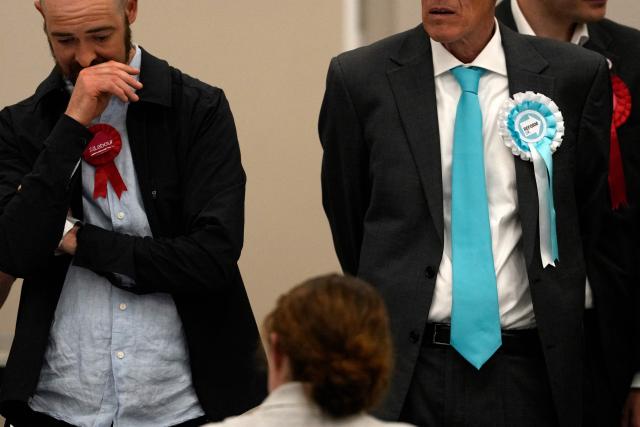 Election agents representing Labour and Reform UK political parties, watch as staff count ballots the morning after local elections at a vote-counting centre in Woolwich in south-east London on May 8, 2026. Nigel Farage, leader of the Britain's hard-right nationalist Reform UK party, vowed Friday it was "here to stay" after winning hundreds of seats in local polls. (Photo by CARLOS JASSO / AFP)