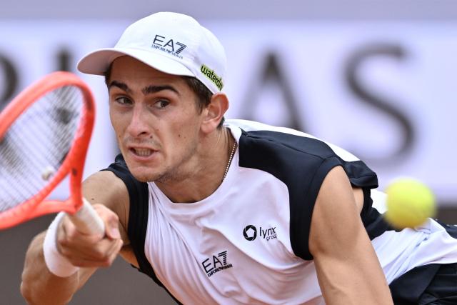 Italy's Matteo Arnaldi plays a forehand return to Australia's Alex de Minaur during their men's singles match of the WTA Rome Open tennis tournament at the Foro Italico in Rome on May 8, 2026. (Photo by Tiziana FABI / AFP)