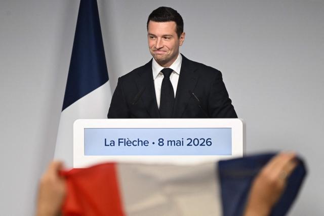 French far-right Rassemblement National RN party's President Jordan Bardella reacts as he delivers a speech following a ceremony marking the 81st anniversary of VE Day, or Victory in Europe Day, which commemorates the end of World War II, in La Fleche, north-western France, on May 8, 2026. (Photo by Sebastien Salom-Gomis / AFP)