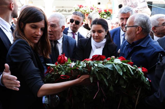 France's junior Minister for Veterans affairs Alice Rufo (L) and other officials lay a wreath and flowers during a commemoration ceremony marking the anniversary of the "1945 Setif massacres" in the eastern city of Setif on May 8, 2026. France announced on May 8,  the return of its ambassador to Algeria, coinciding with a ministerial visit aimed at “building trusting relations” and “restoring effective dialogue” with Algiers, following nearly two years of diplomatic crisis between the two countries. (Photo by AFP)